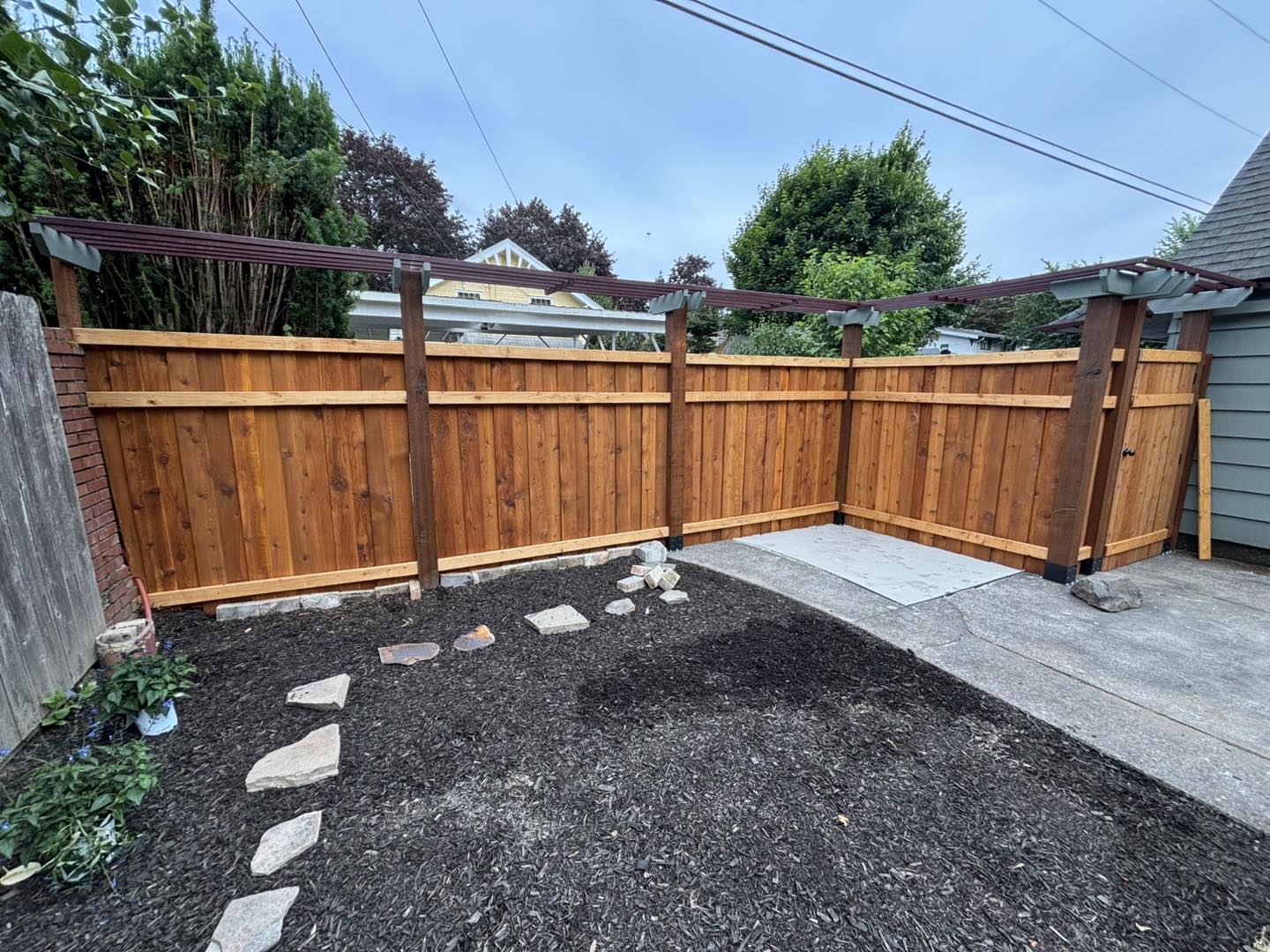 Completed cedar fence with custom gate installation